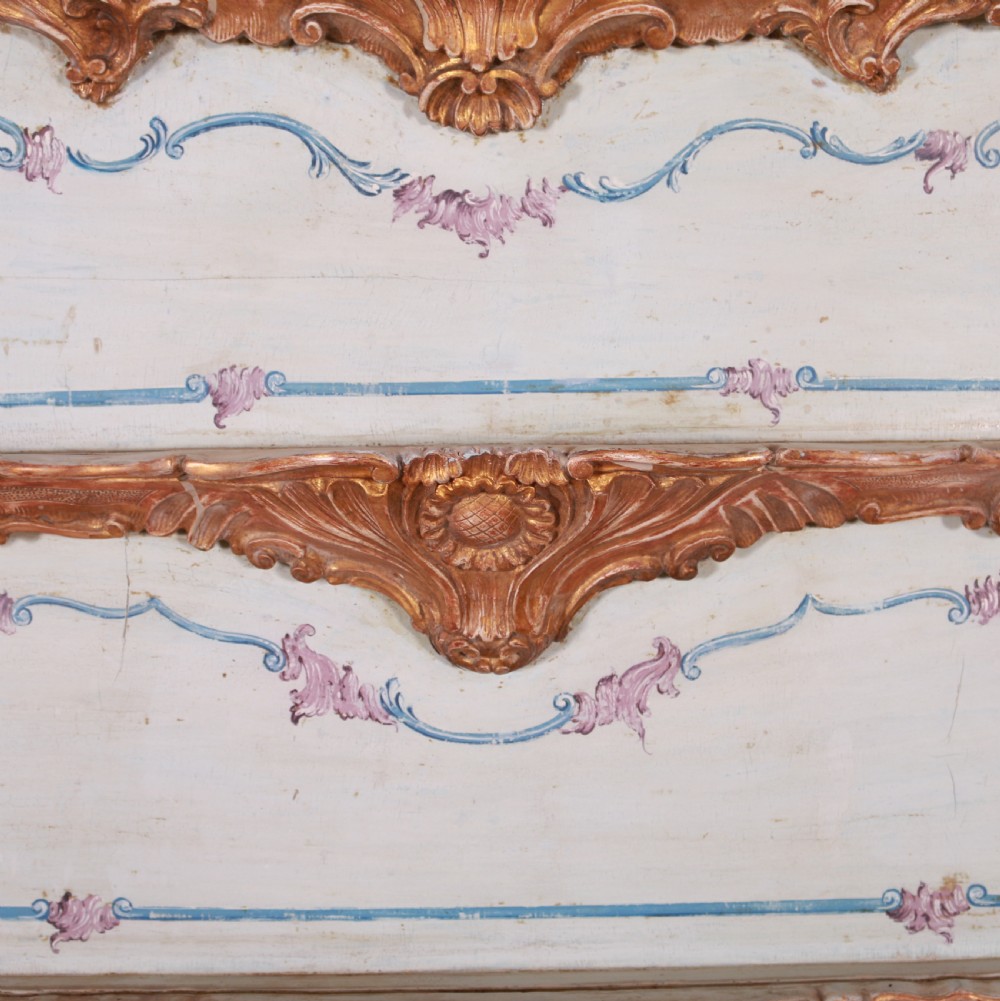 An 18th-century Italian painted credenza featuring four floral-panel doors, giltwood mouldings, and a matching stepped shelf structure mounted above. View IX