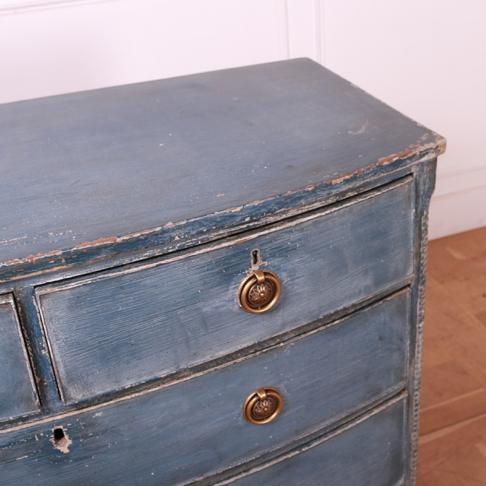 A blue painted bow-front chest of drawers featuring two small drawers over three long drawers with brass ring handles. View VIII