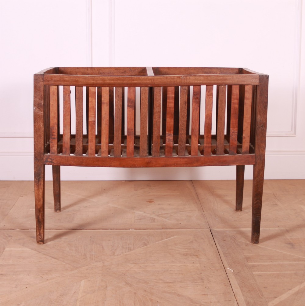 A rectangular rustic wooden log basket featuring vertical slatted sides, a central interior divider, and four tapered legs. View II