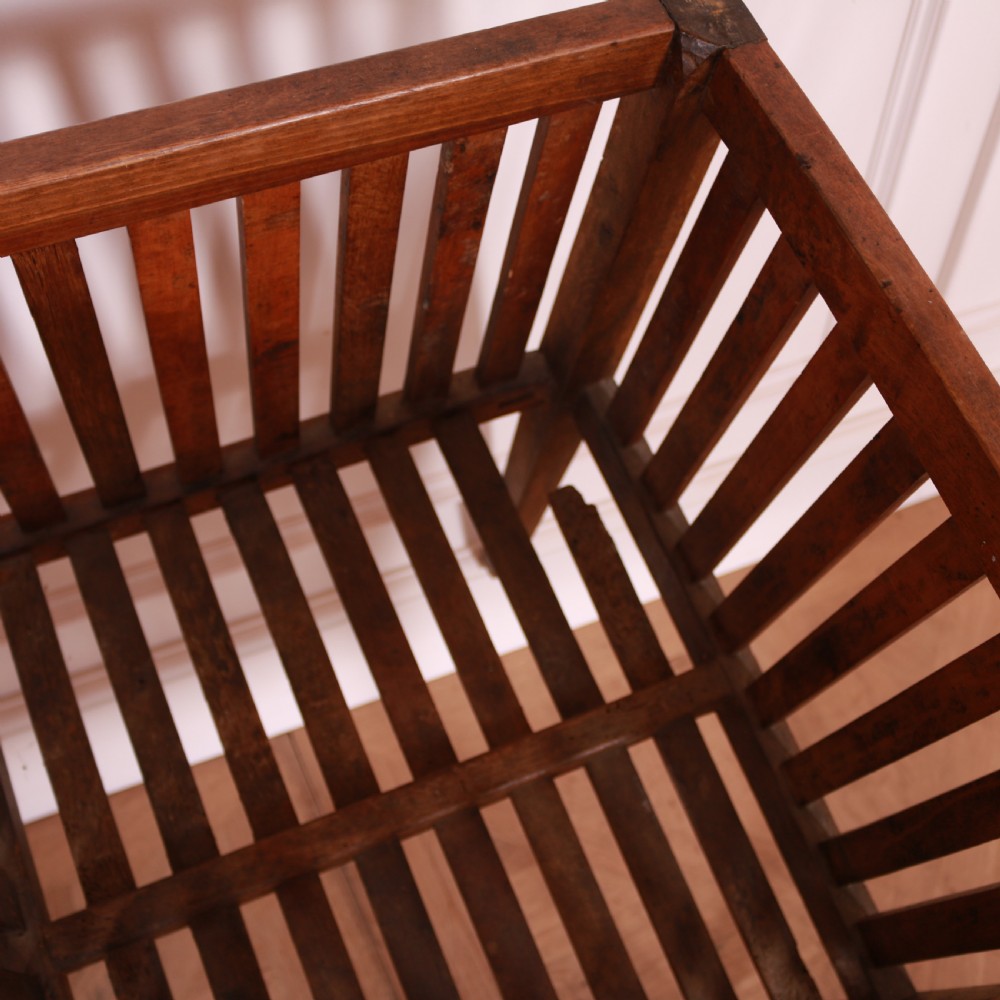 A rectangular rustic wooden log basket featuring vertical slatted sides, a central interior divider, and four tapered legs. View IV