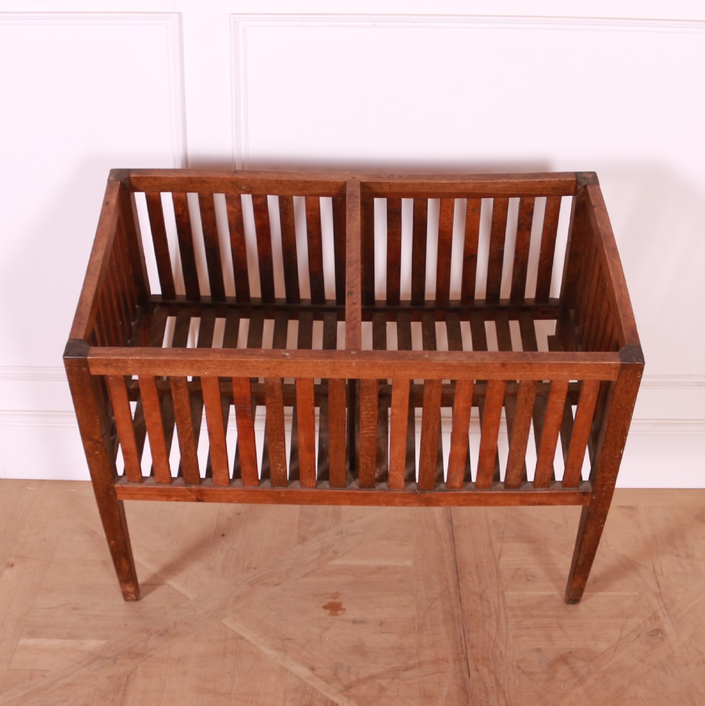A rectangular rustic wooden log basket featuring vertical slatted sides, a central interior divider, and four tapered legs. View V