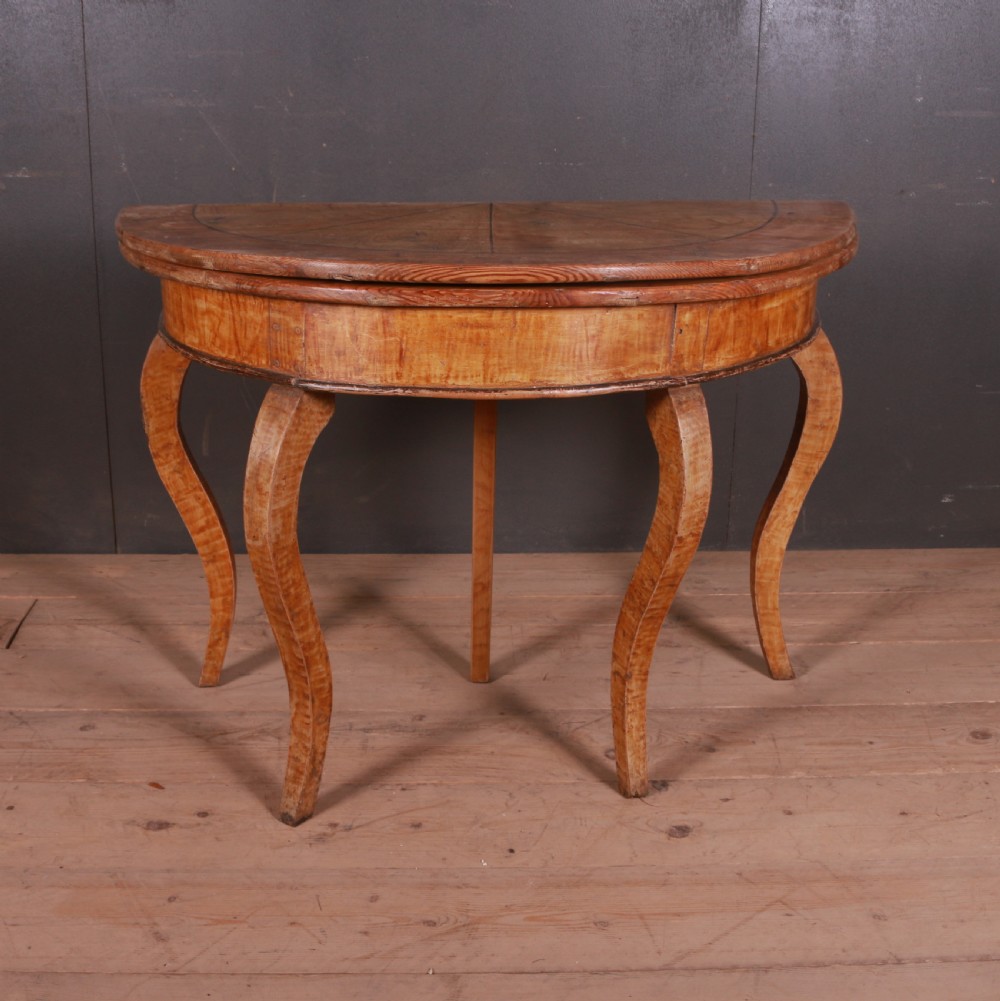 A semi-circular Swedish wooden console table featuring four slender cabriole legs, a fifth gateleg, and a flip-top surface.