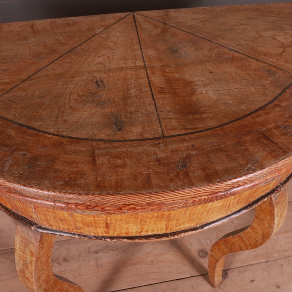 A semi-circular Swedish wooden console table featuring four slender cabriole legs, a fifth gateleg, and a flip-top surface. View IV