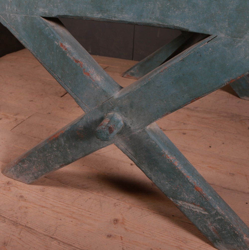 An antique English trestle table featuring a muted teal painted X-frame base, two apron drawers with brass handles, and a scrubbed natural pine top. View XI