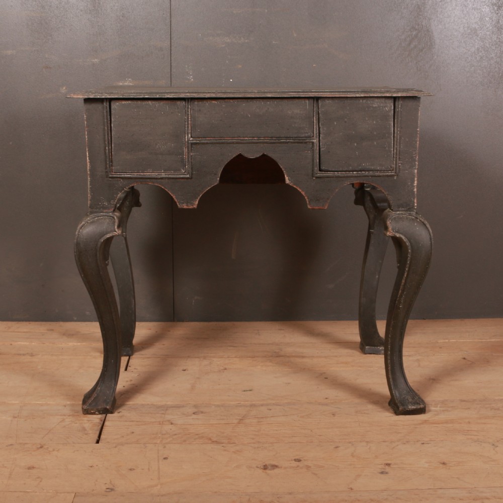 An antique black painted wooden lowboy table featuring a shaped apron and curved cabriole legs. View V