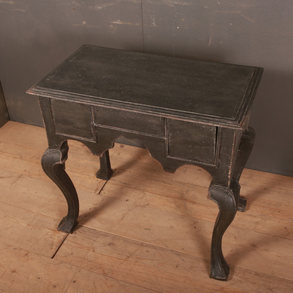 An antique black painted wooden lowboy table featuring a shaped apron and curved cabriole legs. View VI