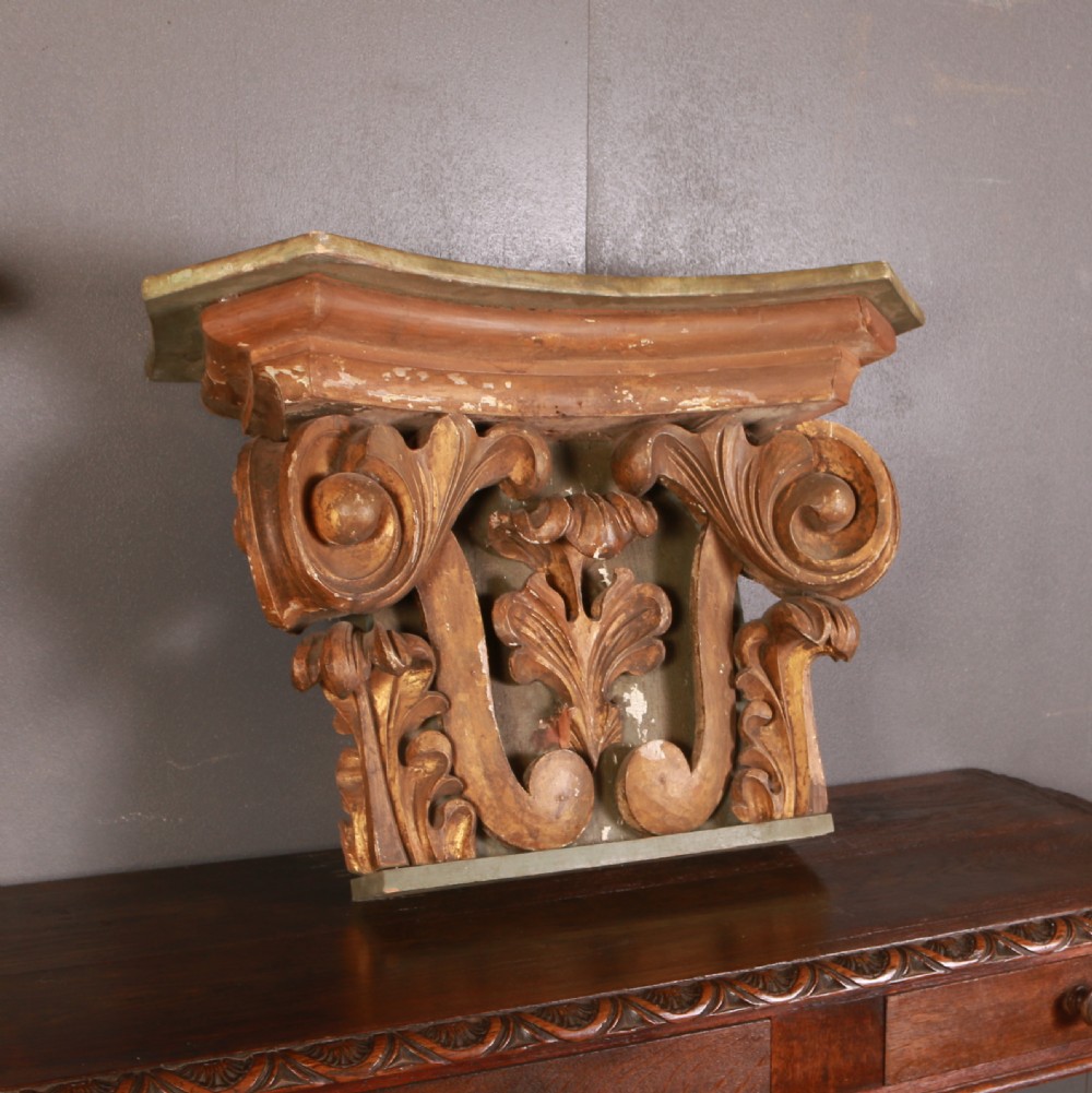 A pair of carved wooden Italian architectural capitals with acanthus leaf carving and distressed gilding. View III