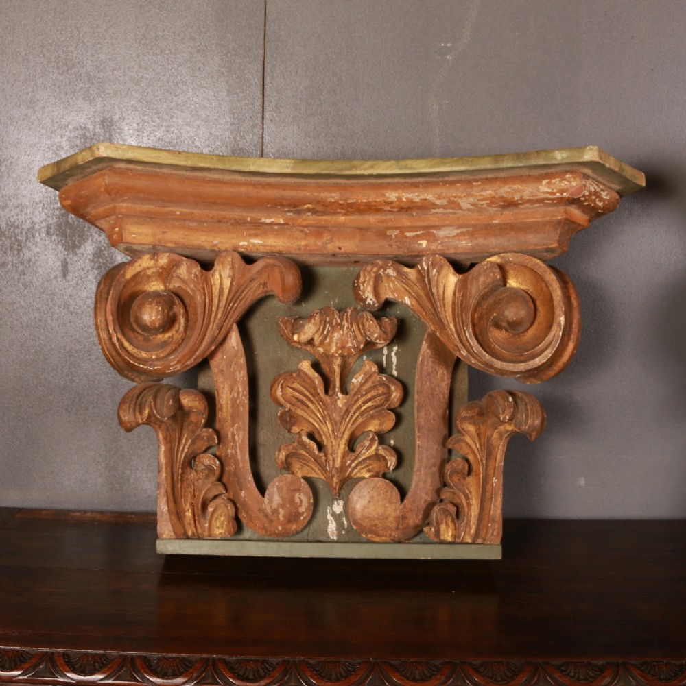 A pair of carved wooden Italian architectural capitals with acanthus leaf carving and distressed gilding. View IV