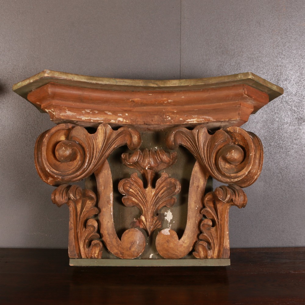 A pair of carved wooden Italian architectural capitals with acanthus leaf carving and distressed gilding. View V