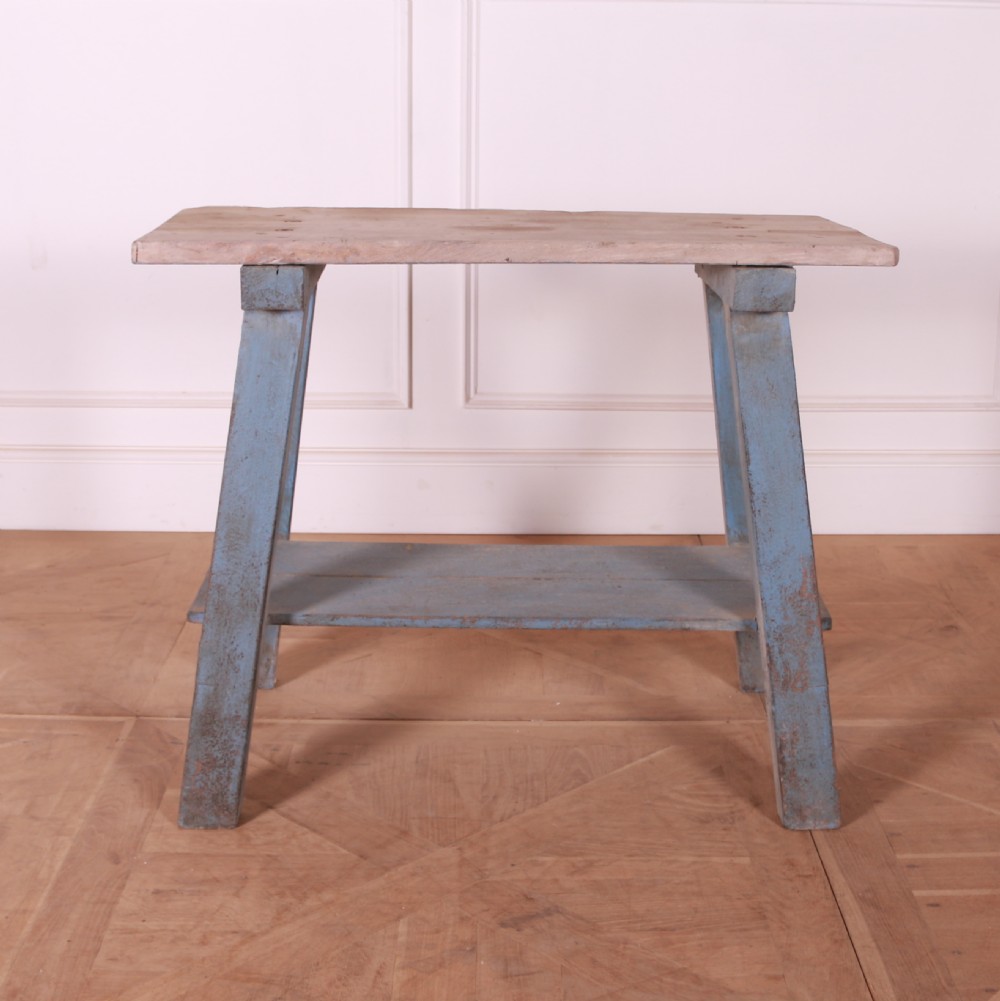 A rustic pine trestle table featuring a natural unpainted wood top and distressed blue painted A-frame legs with a lower storage shelf. View IV