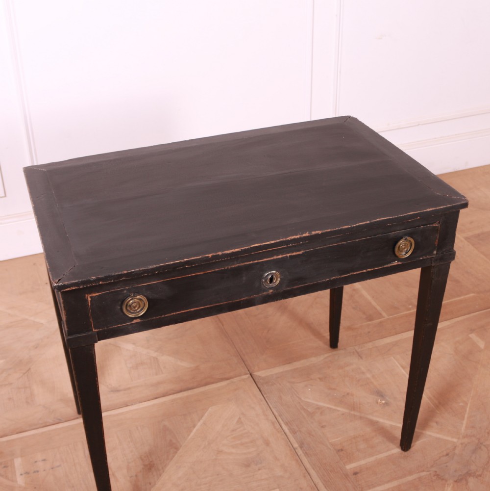 A rectangular black painted French side table featuring a single frieze drawer, brass handles, and square tapered legs. View IV