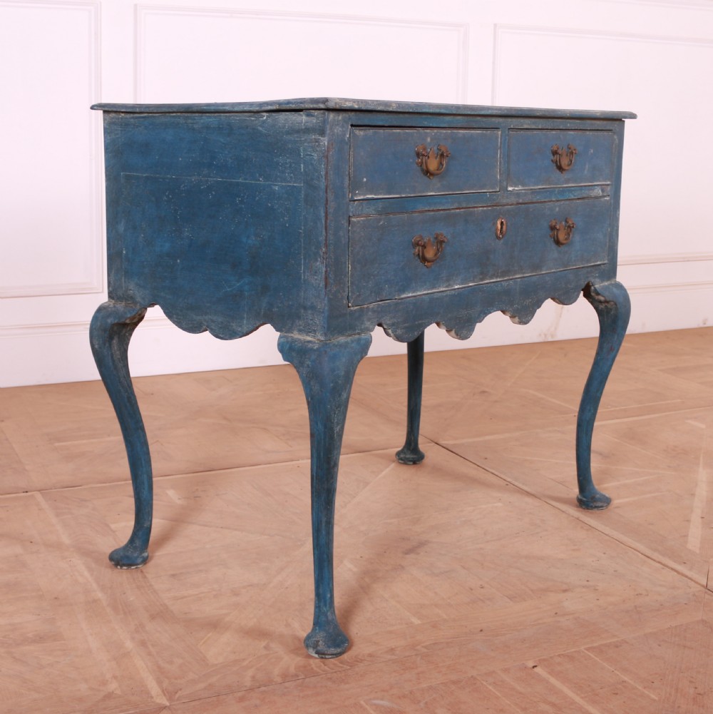An eighteenth-century blue painted lowboy featuring three drawers with brass handles, a scalloped apron, and cabriole legs. View II