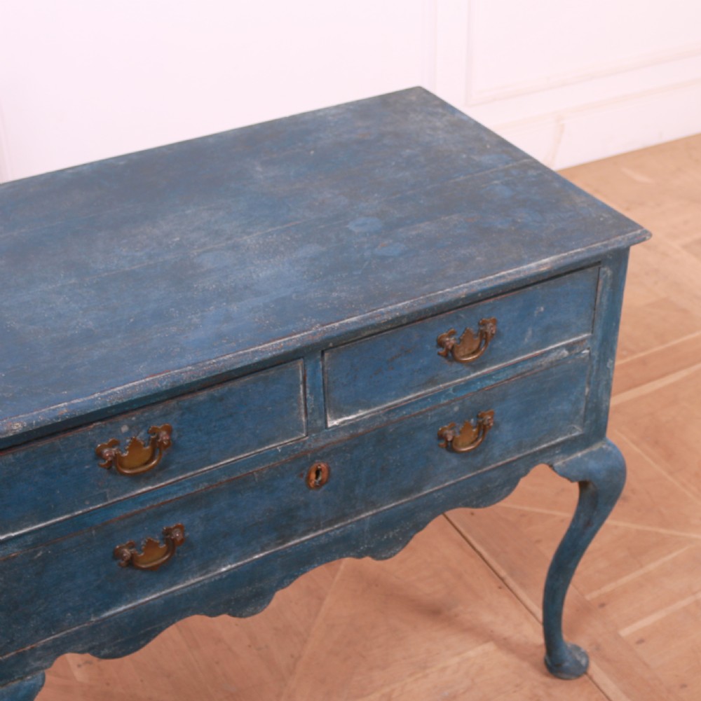 An eighteenth-century blue painted lowboy featuring three drawers with brass handles, a scalloped apron, and cabriole legs. View V