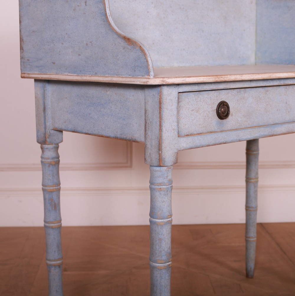 A pale blue painted side table featuring a raised gallery back, single drawer with two circular metal knobs, and ring-turned legs. View III