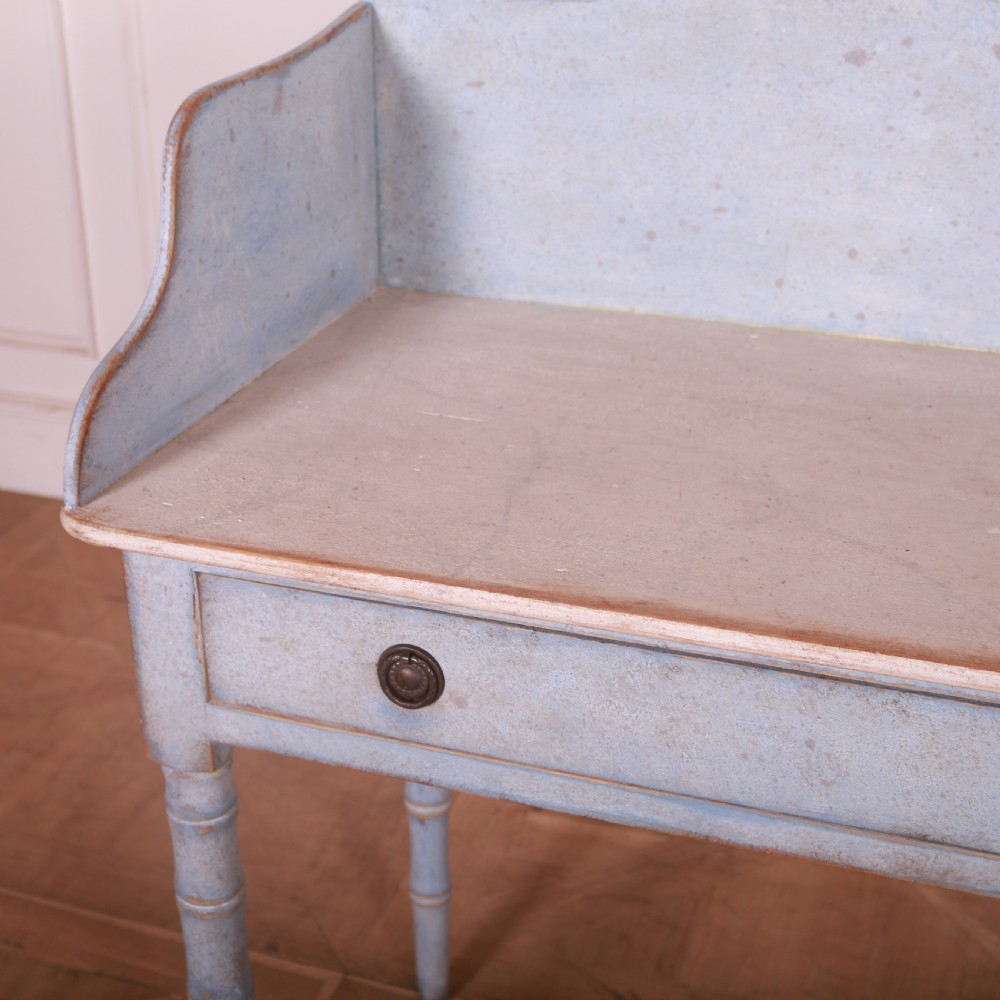 A pale blue painted side table featuring a raised gallery back, single drawer with two circular metal knobs, and ring-turned legs. View V