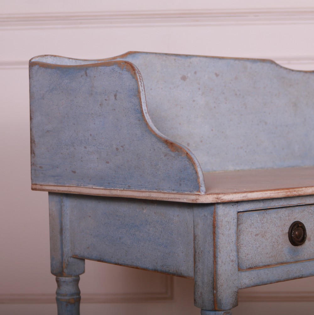 A pale blue painted side table featuring a raised gallery back, single drawer with two circular metal knobs, and ring-turned legs. View VI