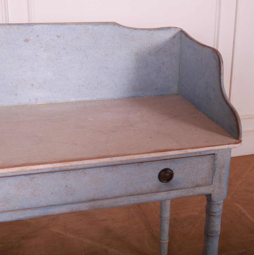 A pale blue painted side table featuring a raised gallery back, single drawer with two circular metal knobs, and ring-turned legs. View VII
