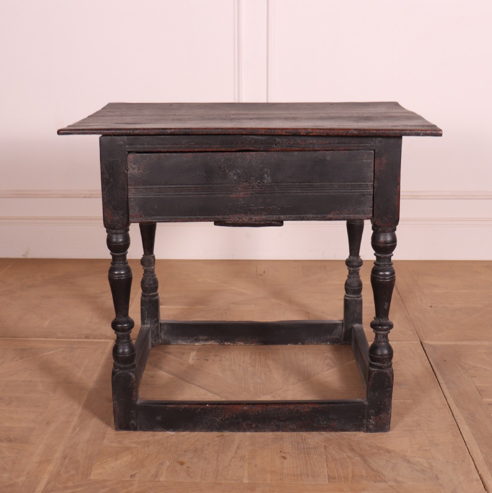 An 18th-century dark painted wooden side table with a single drawer, turned legs, and low box stretchers. View III