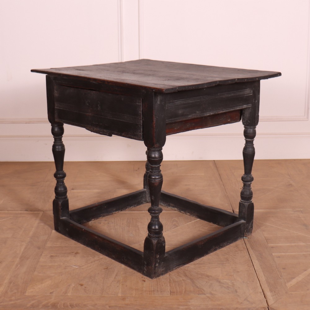 An 18th-century dark painted wooden side table with a single drawer, turned legs, and low box stretchers. View IV