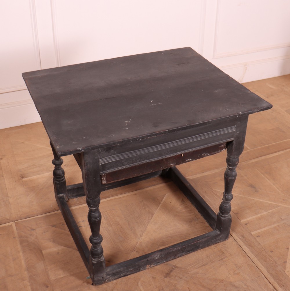 An 18th-century dark painted wooden side table with a single drawer, turned legs, and low box stretchers. View VII