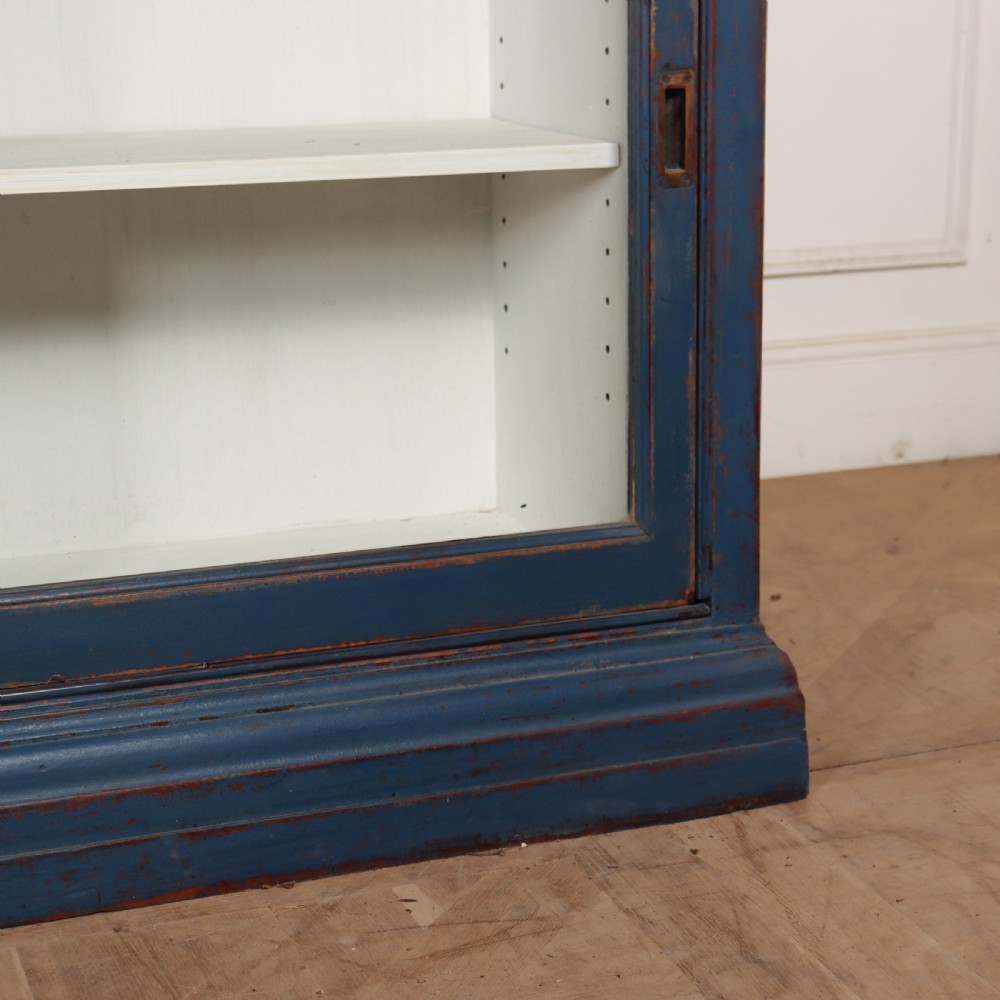 A large two-tier blue painted display cabinet featuring sliding glass doors and a white painted interior fitted with shelves. View VIII