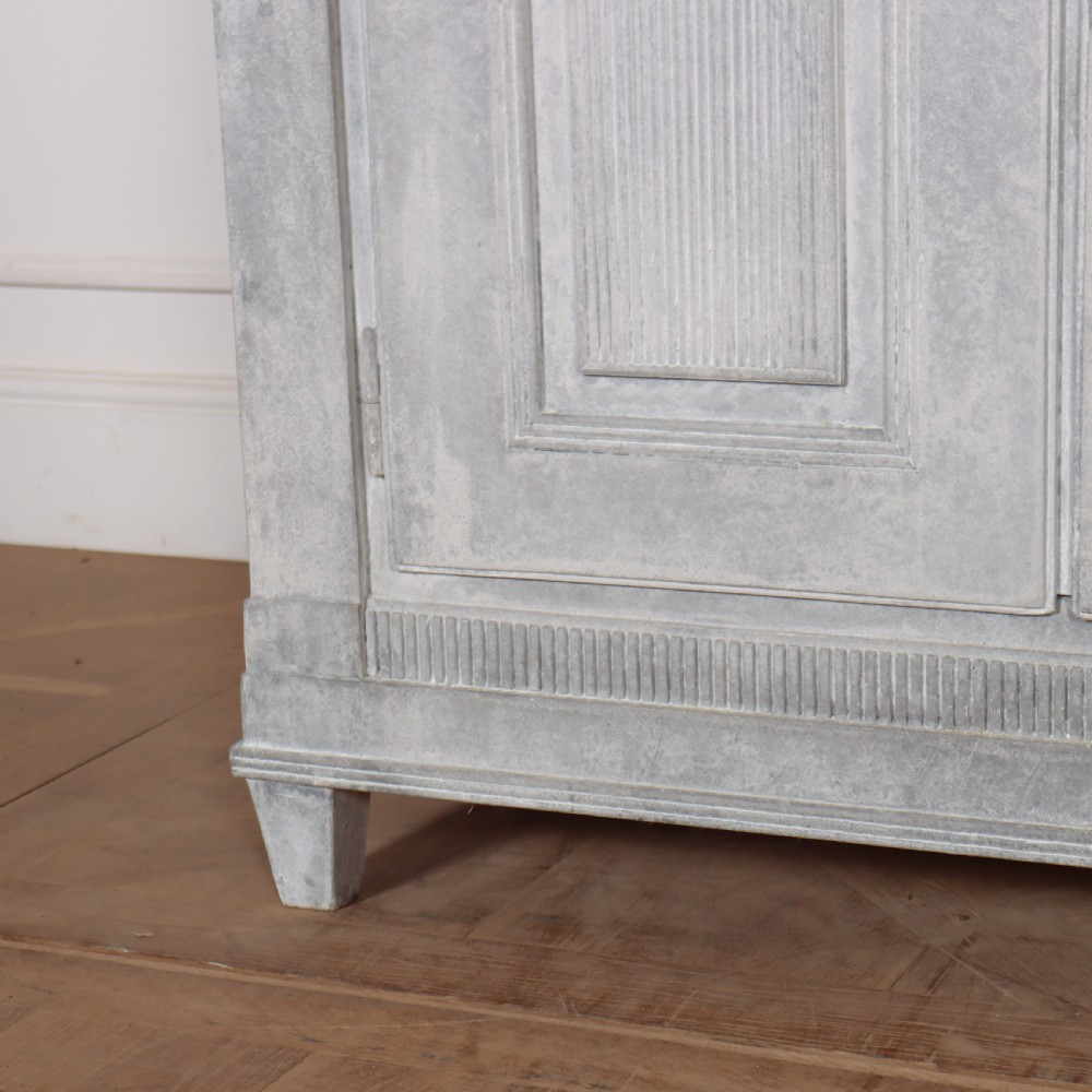 A pair of Swedish enfilades featuring a distressed pale grey painted finish, panelled cupboard doors, small round brass knobs, and short tapered legs. View VI