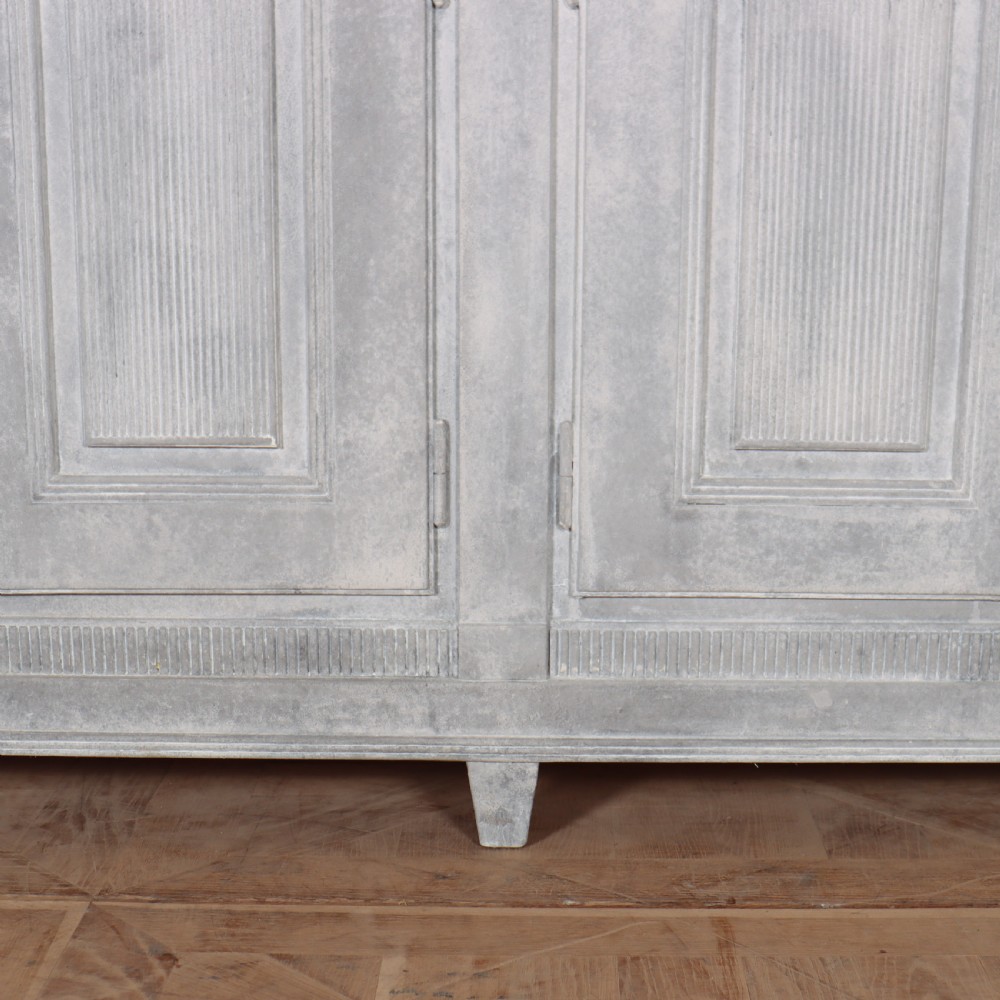 A pair of Swedish enfilades featuring a distressed pale grey painted finish, panelled cupboard doors, small round brass knobs, and short tapered legs. View IX