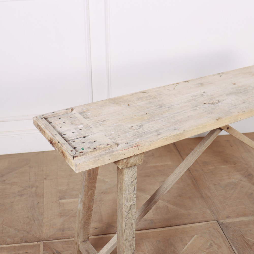 A narrow French bleached oak trestle table featuring a slim rectangular timber top supported by angled trestle legs with diagonal cross bracing. View II