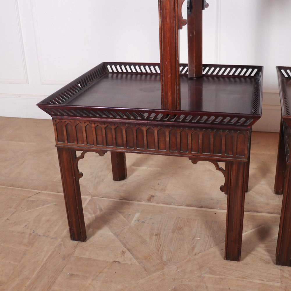 A set of three dark mahogany lamp tables featuring pierced gallery rims and Gothic arch fretwork aprons. View II
