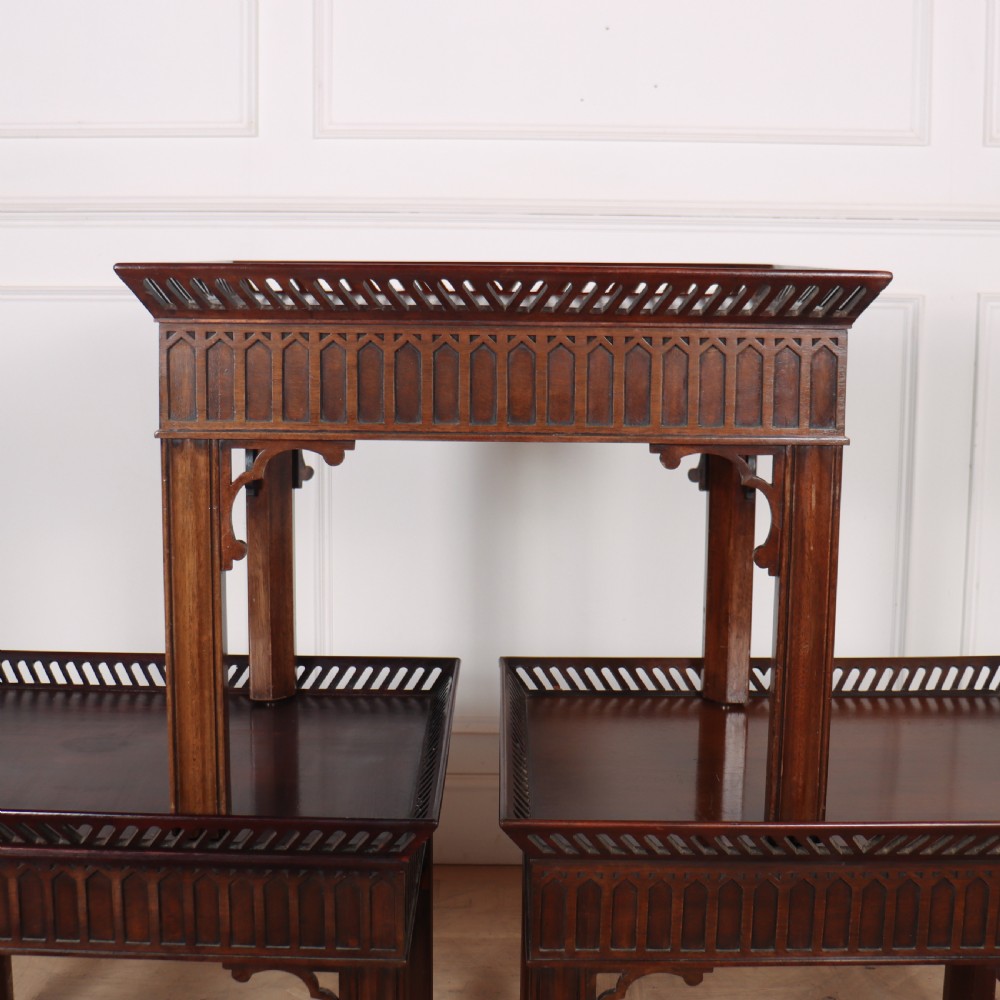 A set of three dark mahogany lamp tables featuring pierced gallery rims and Gothic arch fretwork aprons. View VI