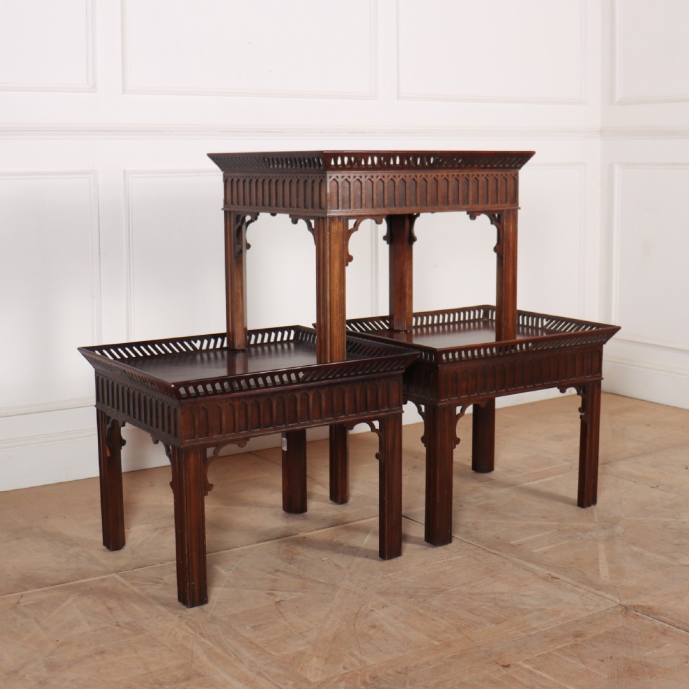 A set of three dark mahogany lamp tables featuring pierced gallery rims and Gothic arch fretwork aprons. View VII