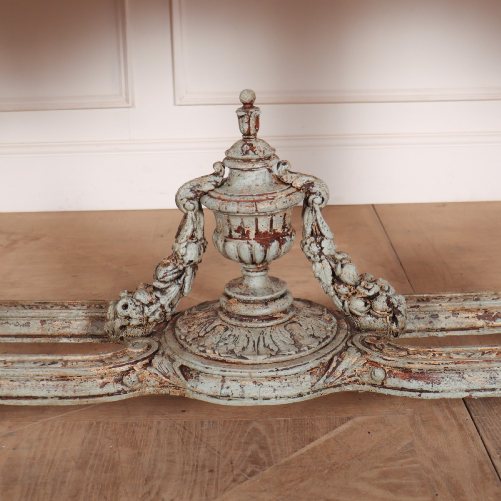 A carved Spanish console table featuring distressed pale blue paintwork, a dark rectangular top, an intricate carved apron, and a central urn finial stretcher. View VII