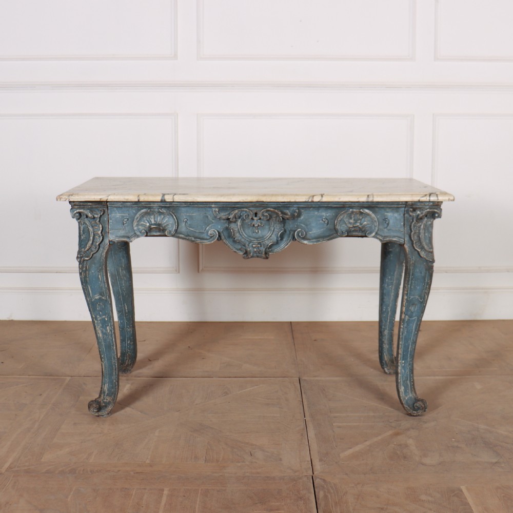 An 18th-century Italian Rococo console table featuring a grey and cream marble top over a distressed blue painted frame with carved scrollwork and cabriole legs.