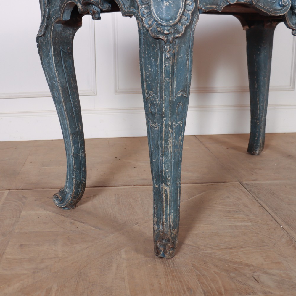 An 18th-century Italian Rococo console table featuring a grey and cream marble top over a distressed blue painted frame with carved scrollwork and cabriole legs. View III