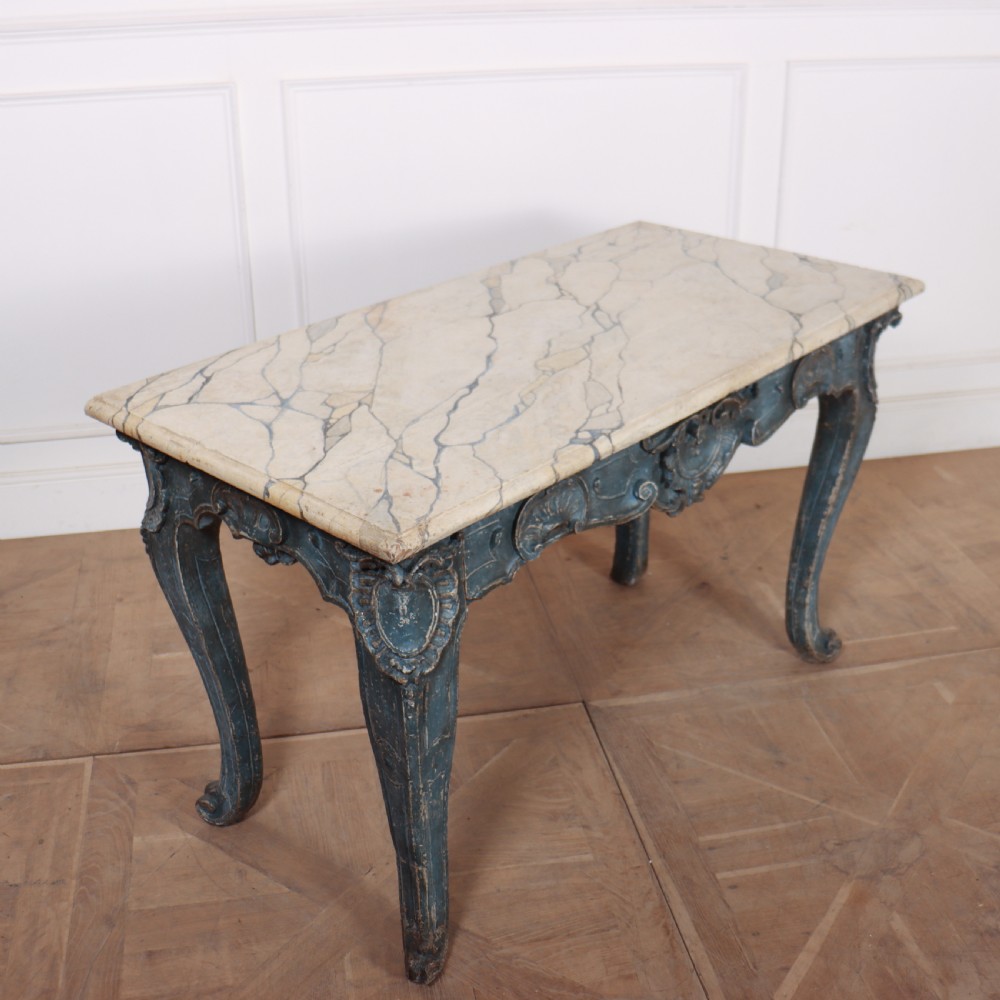 An 18th-century Italian Rococo console table featuring a grey and cream marble top over a distressed blue painted frame with carved scrollwork and cabriole legs. View IV