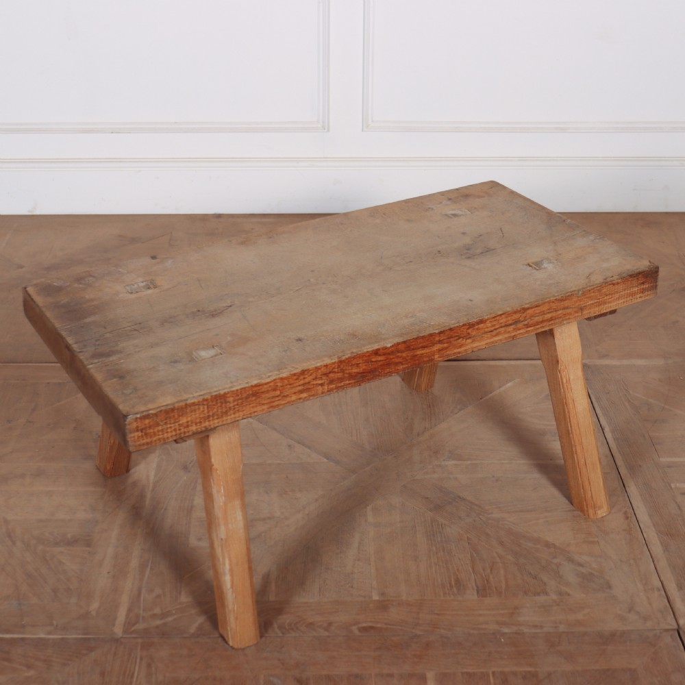 A low French primitive rectangular coffee table made of rustic warm brown timber with splayed tapered legs. View III