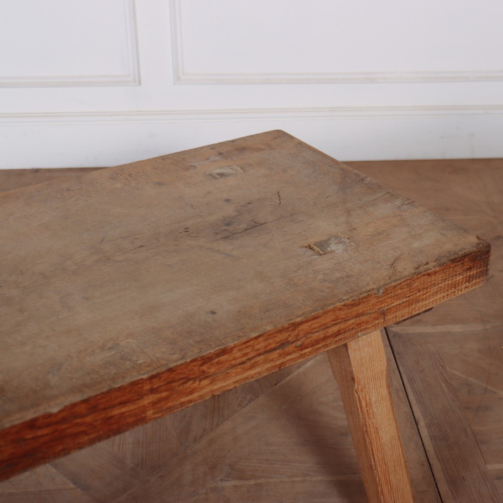 A low French primitive rectangular coffee table made of rustic warm brown timber with splayed tapered legs. View IV