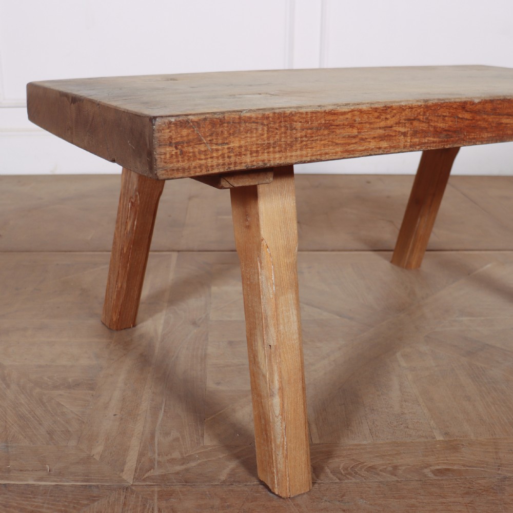 A low French primitive rectangular coffee table made of rustic warm brown timber with splayed tapered legs. View V