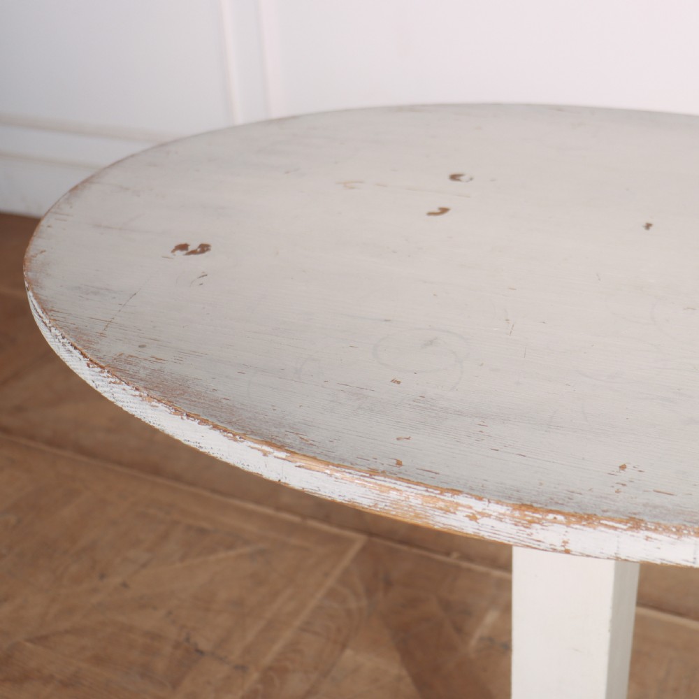 An off-white painted Swedish pedestal table featuring a circular top, a square central column, and a stepped plinth base with visible paint wear along the edges. View IV