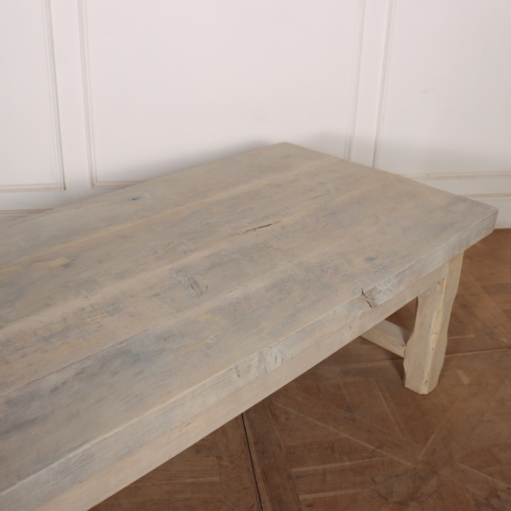 A low rectangular French coffee table constructed from bleached oak, featuring a thick plank top, square legs, a low stretcher, and a small end drawer. View IV