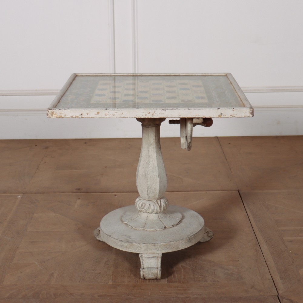 A square painted lamp table featuring a grid of heraldic coats of arms on a cream ground, supported by a carved off-white pedestal base. View II
