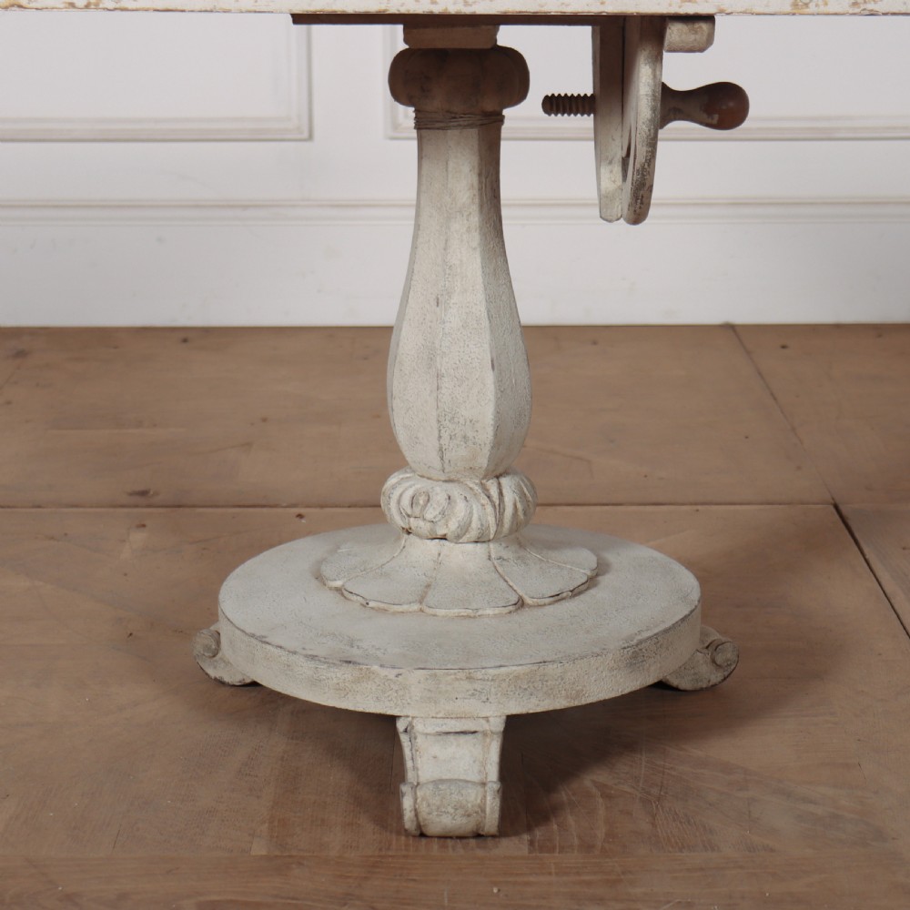 A square painted lamp table featuring a grid of heraldic coats of arms on a cream ground, supported by a carved off-white pedestal base. View III