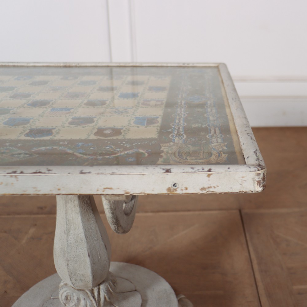 A square painted lamp table featuring a grid of heraldic coats of arms on a cream ground, supported by a carved off-white pedestal base. View IV