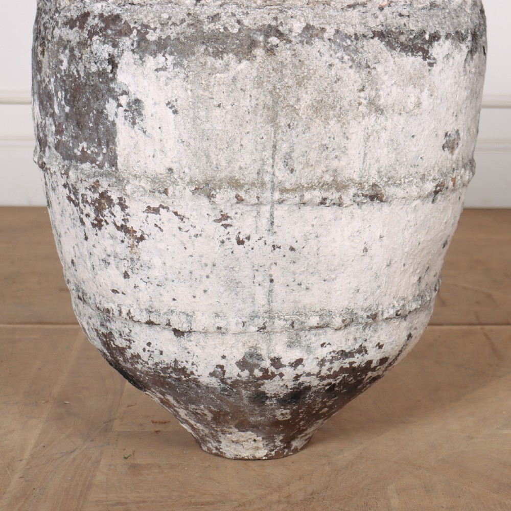 A large, tapered terracotta olive jar featuring a heavily distressed off-white painted surface over dark earthenware clay with a rolled rim. View III