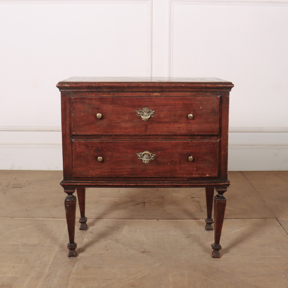 An 18th-century Italian walnut commode with two drawers, raised on tapered square legs with decorative brass fittings. View II
