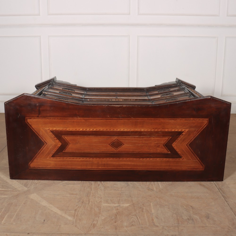 An 18th-century Italian walnut commode featuring four drawers with geometric parquetry inlay and gilt brass pilaster mounts. View X