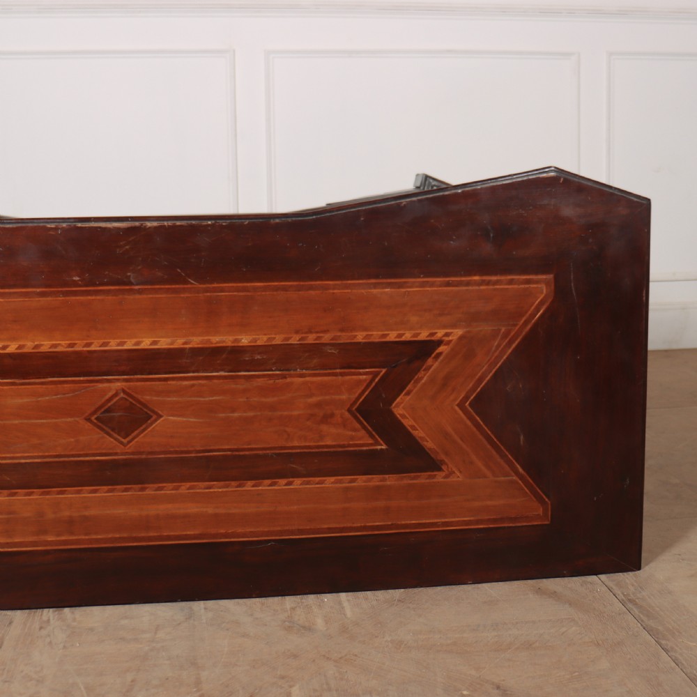 An 18th-century Italian walnut commode featuring four drawers with geometric parquetry inlay and gilt brass pilaster mounts. View XII
