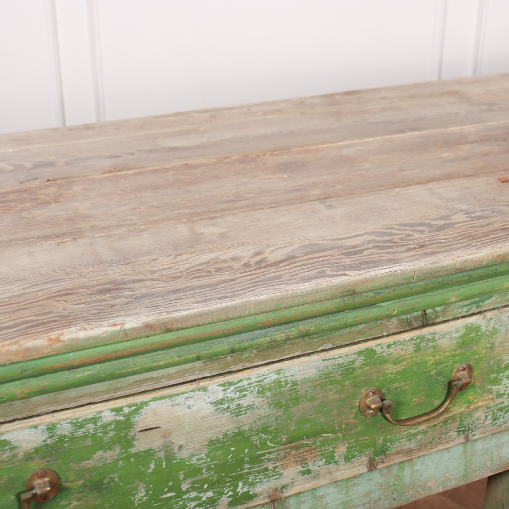 An exceptionally long antique English pine dresser base featuring a distressed green painted finish, four drawers with drop handles, and an unpainted timber top surface. View V