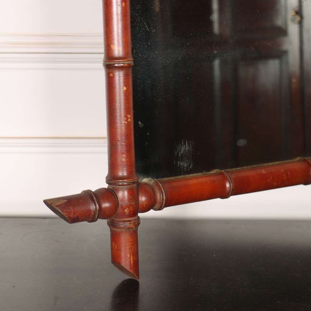 A rectangular French wall mirror featuring a carved wooden frame crafted to imitate bamboo with crossed, protruding corner joints. View V