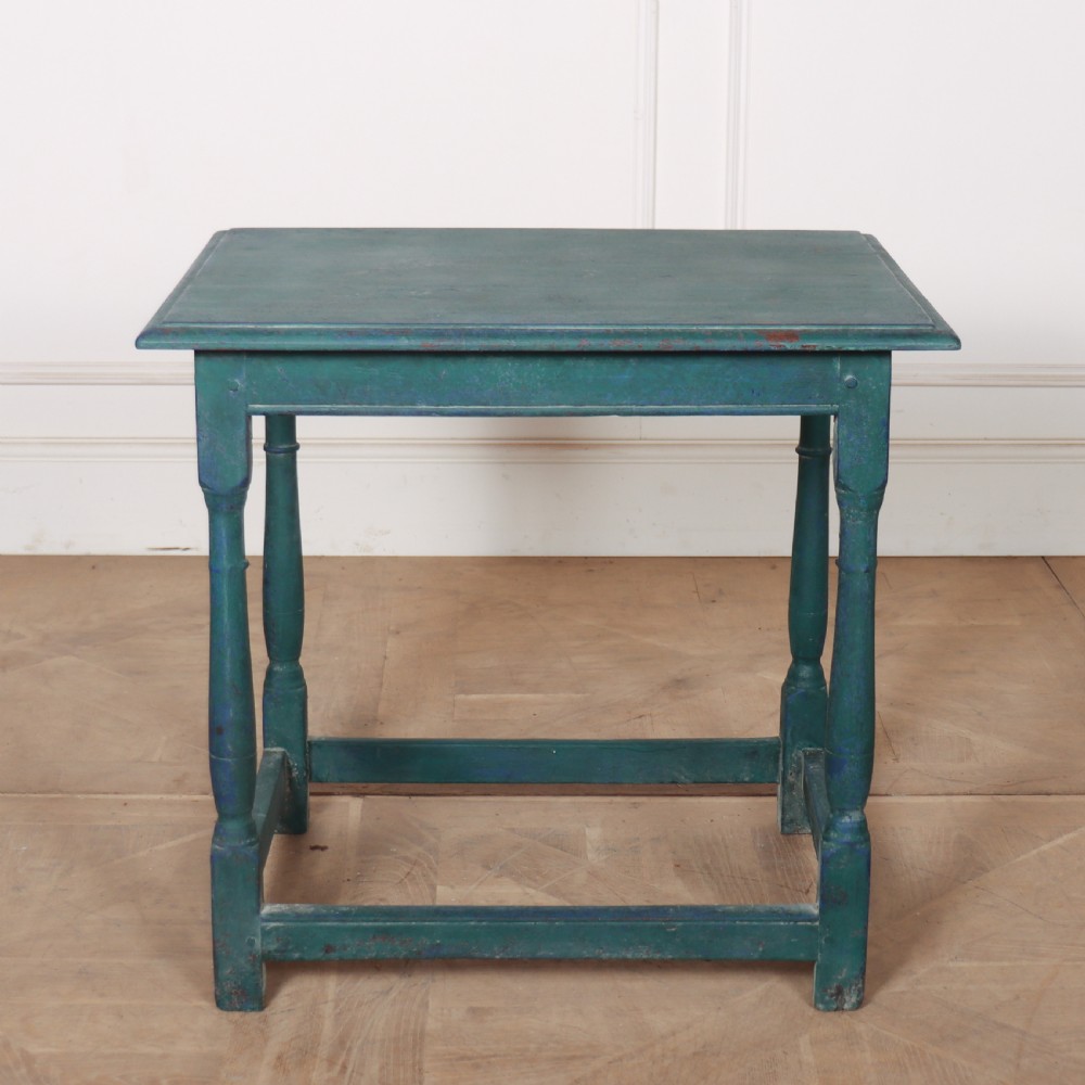 An 18th-century rectangular wooden side table featuring turned legs, box stretchers, and a distressed teal green painted finish.